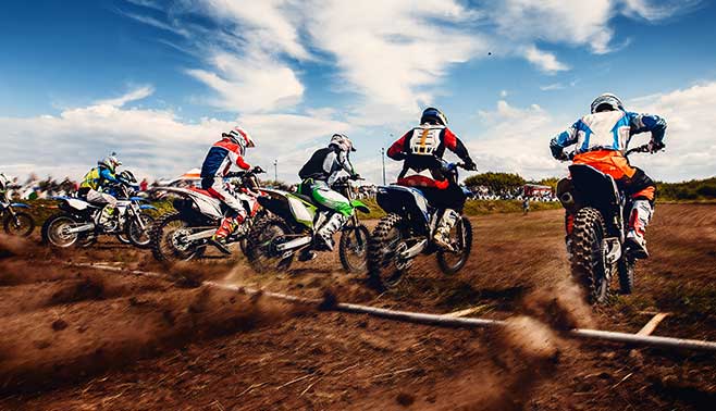 Motocross rider taking off from the starting line.